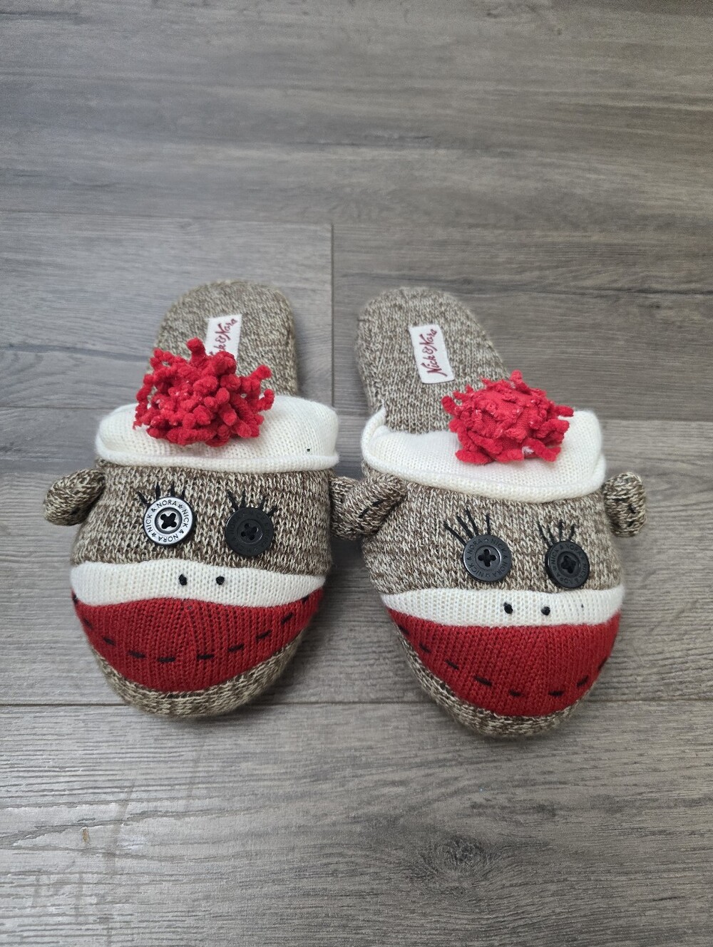 Nick & Nora brand sock monkey slippers in brown and white with red pom-poms